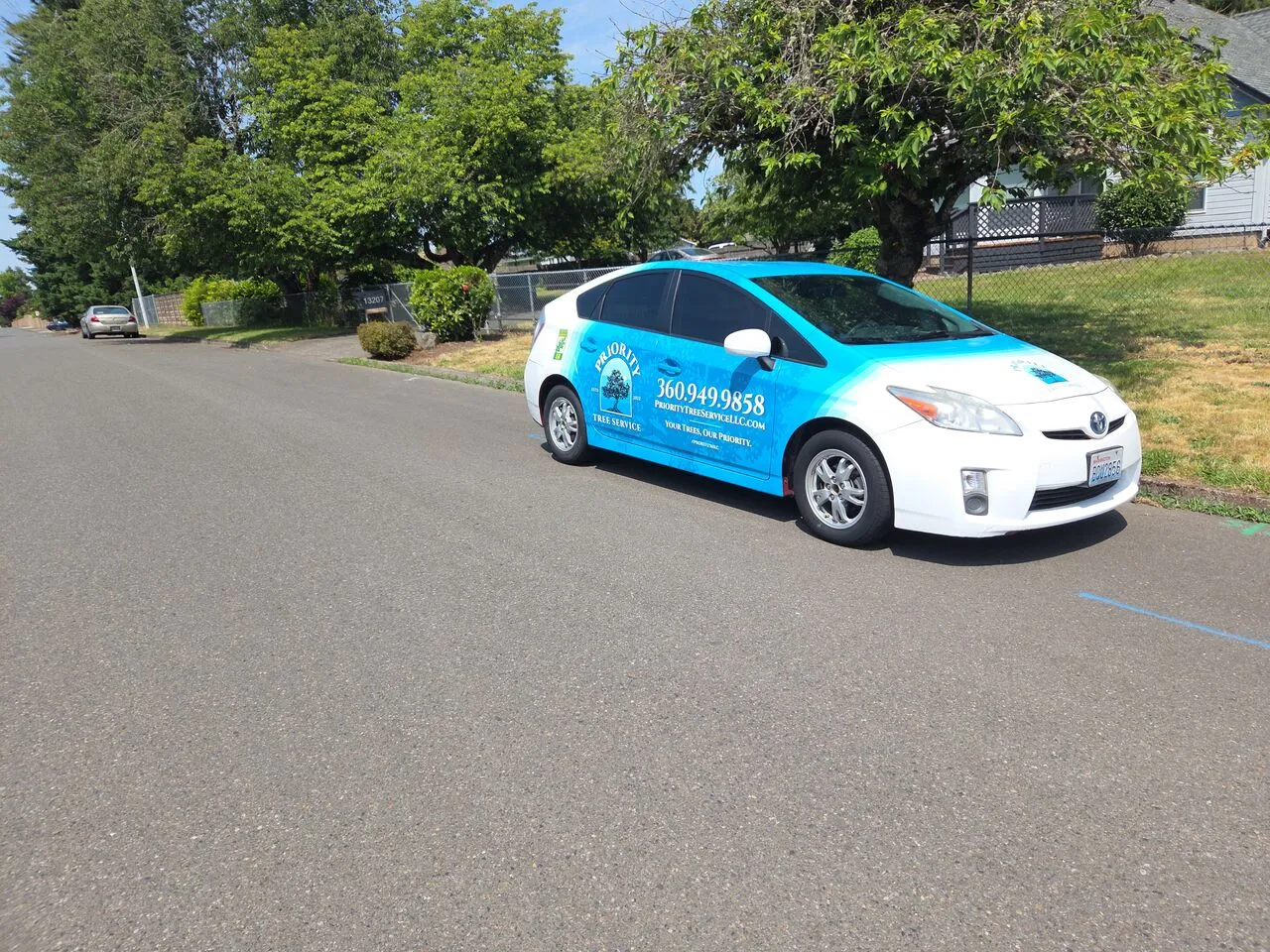 Branded Priority Tree Service company car parked on a residential street in Hazel Dell, WA